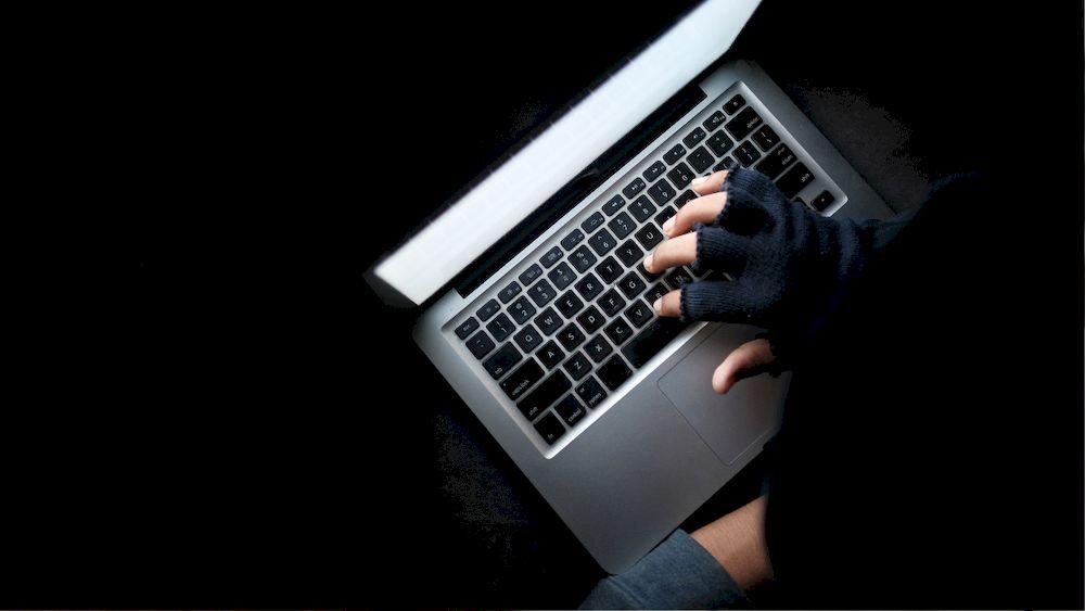 Un hacker con la mano sobre el teclado preparando ataque