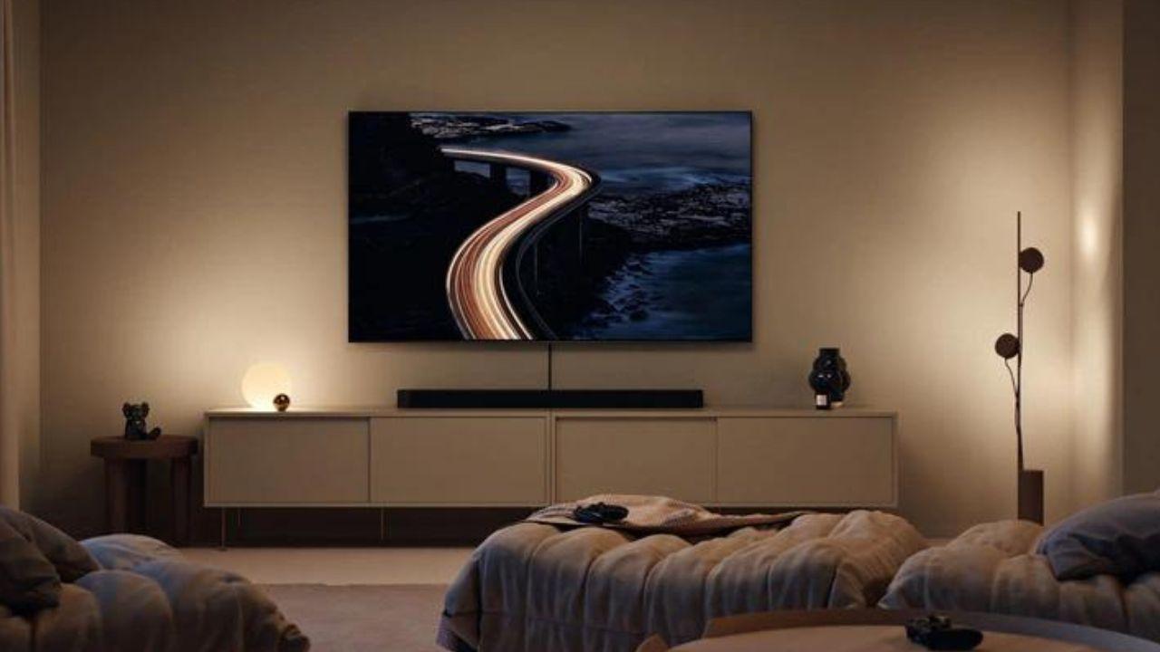 La Smart TV modelo Samsung TQ65QN90CATXXC en un salón con sofás