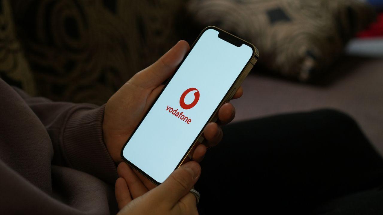 A mobile phone with the Vodafone logo on the screen
